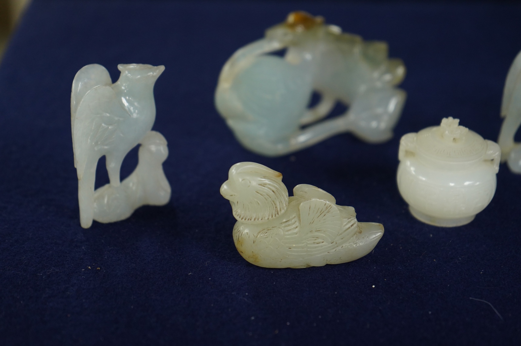 A Chinese jade figure of a Mandarin duck and a miniature pot and cover, three jadeite carvings and a bowenite dragon, 16.5cm